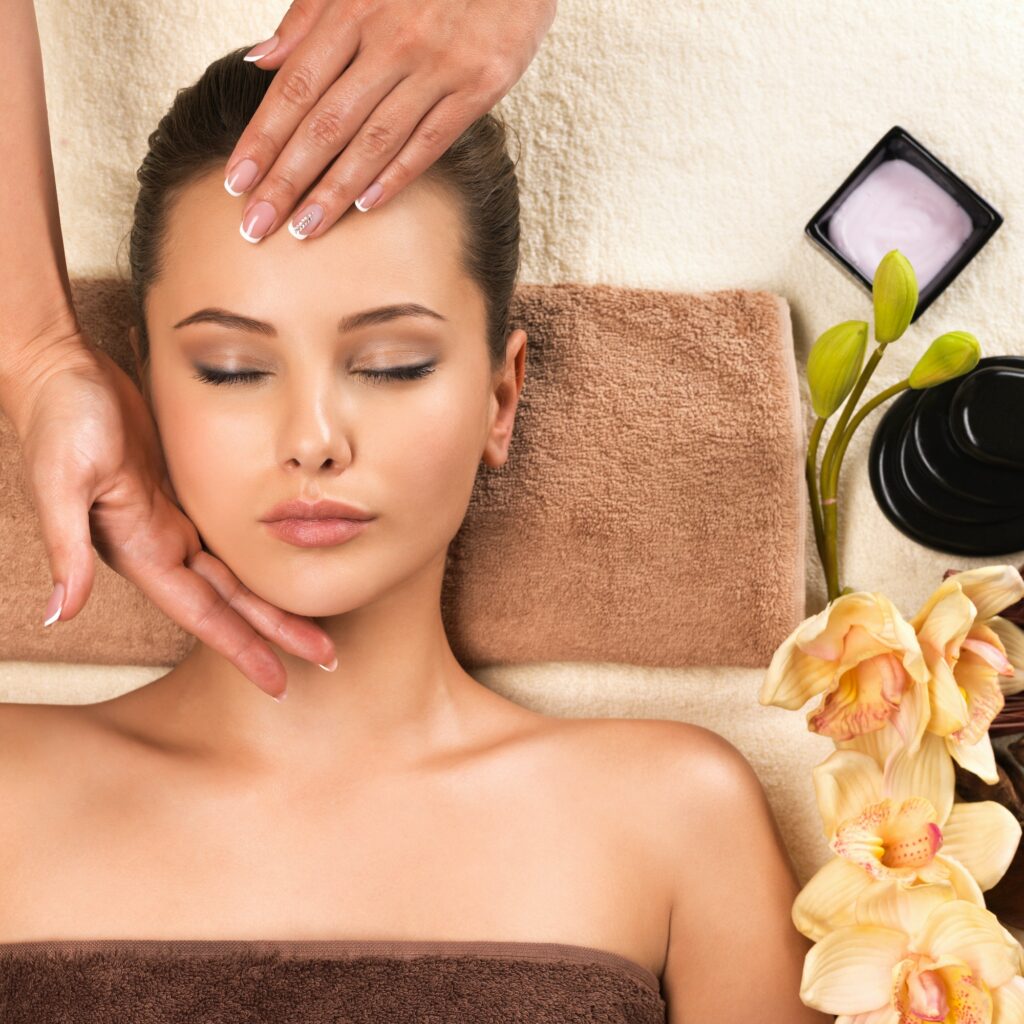 Beautiful young woman relaxing with head massage.