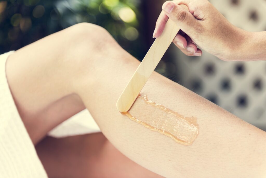 Woman getting legs waxed at a spa